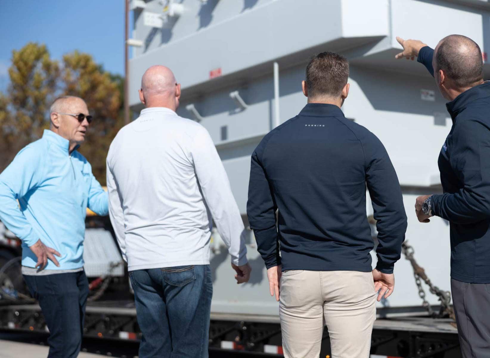 CORE Transformers® team beside a transformer